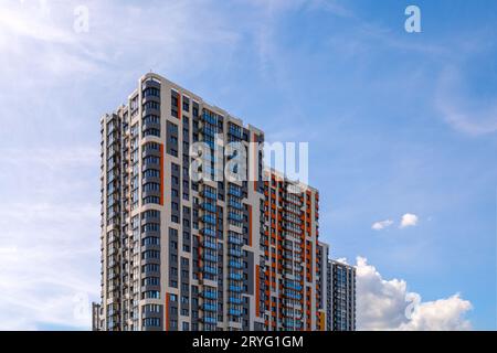 freshly built high rise apartment building on blue sky background Stock ...