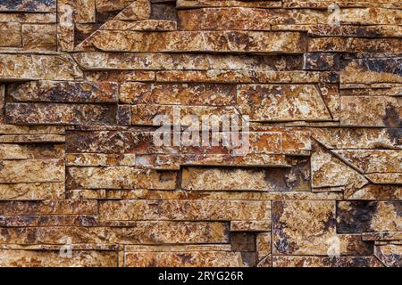 Fake stone wall, plastic panel imitating natural slab wall brickwork Stock Photo