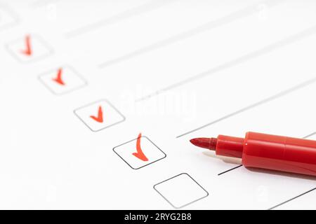 Checklist sheet and red marker. Check list completed task concept Stock Photo