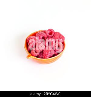 Small bowl of fresh organic raspberries isolated on white background. Cooking ingredient. Stock Photo