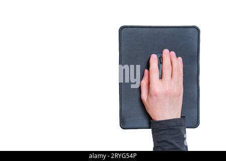 Top view of a male hand placed on top of a wireless computer mouse set on a white background with copy space. Stock Photo
