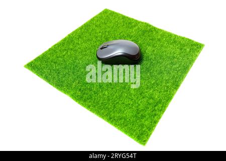 Computer mouse resting on a vibrant synthetic grass mat. Stock Photo