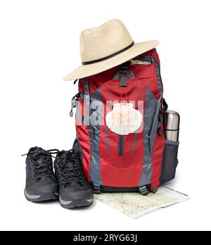 Pilgrim backpack with scallop symbol, hat and boots isolated on white background. Camino de Santiago Pilgrimage equipment Stock Photo