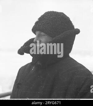 Winter at sea in the 1940s. Pictured a crewmember of the swedish icebreaker Ymer breaking the ice in the inner waters at the swedish coast in febrary 1941. The icebreaker Ymer was built in Malmö 1931-1933 and served as a state icebreaker for 44 years until she was sold and scrapped 1976. The winters during the World war II was often exceptionally cold and the ice became a big problem for the shipping industry and for the military. Ymer was the first big sea icebreaker using a diesel electrical propulsion system, a way of powering ships that today is common. The winters during the time of the w Stock Photo