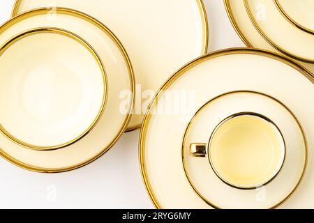 A set of golden luxury ceramic kitchen utensils on a white background Stock Photo