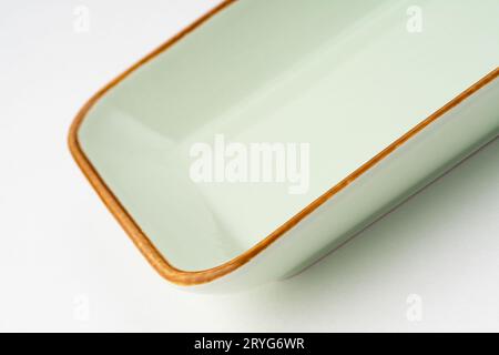 A one ceramic green rectangular plate isolated on white background Stock Photo