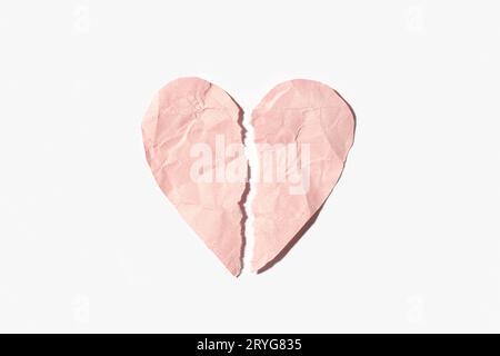 Broken heart made of pink crumpled paper isolated on white background Stock Photo