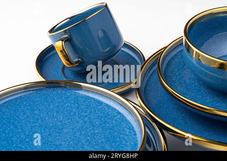 A set of blue ceramic plates and cup on a white background Stock Photo