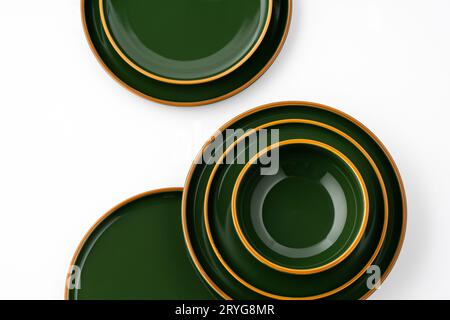 A set of green ceramic plates and bowl on a white background. Top view Stock Photo