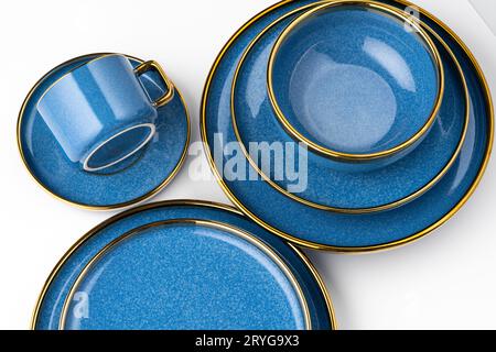 A set of blue ceramic plates and cup on a white background Stock Photo