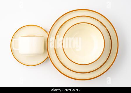 A set of white and brown ceramic plate and cup on a white background. Top view Stock Photo