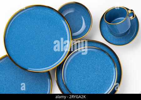 A set of blue ceramic plates and cup on a white background. Top view Stock Photo