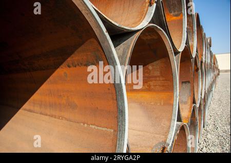 A line of oilfield large streel pipes in industrial construction area Stock Photo