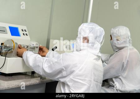 The workers in the workshop for the production and quality control of the internal parts of medical syringes Stock Photo