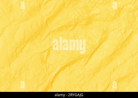 Crumpled paper abstract background texture. Yellow color. Full frame Stock Photo