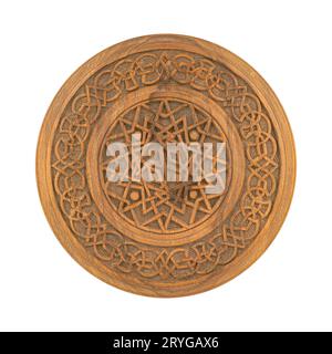 A wooden carved ornamental plate isolated on a white background Stock Photo