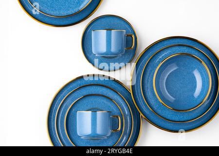 A set of blue ceramic plates and cup on a white background. Top view Stock Photo