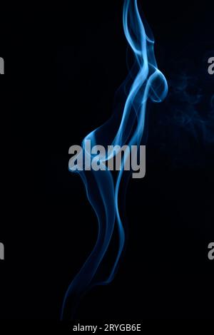 A vertical shot of blue tobacco smoke on a black background Stock Photo