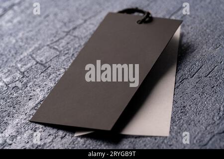 A closeup shot of a blank black clothing tag on a string for a price label on a cloth Stock Photo