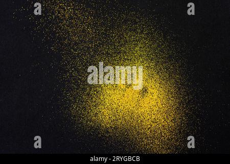 A minimal golden sand texture on a black background Stock Photo