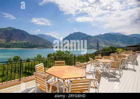 A beautiful shot of outdoor cafe seats near the shore on a resort in the mountains of Central Asia Stock Photo