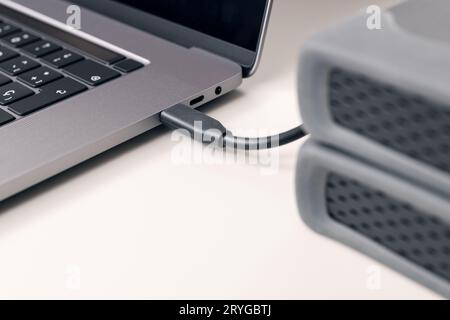 Detail of External hard disk cable connected to a modern laptop computer Stock Photo