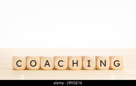 Coaching word on wooden blocks. Copy space Stock Photo