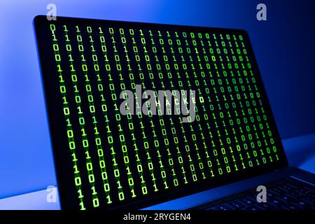 Computer Hacked concept. Laptop screen with hacked word and binary code background Stock Photo