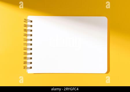 Blank paper notebook Isolated on yellow background. Template mock up Stock Photo