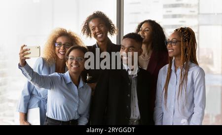 Smiling African American business people colleagues taking selfie on smartphone Stock Photo