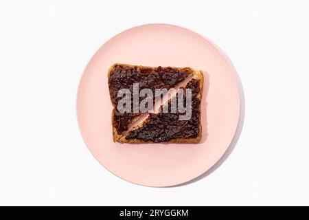 Toast of Whole wheat sandwich bread and organic jam on plate isolated on white background. Flat lay Stock Photo