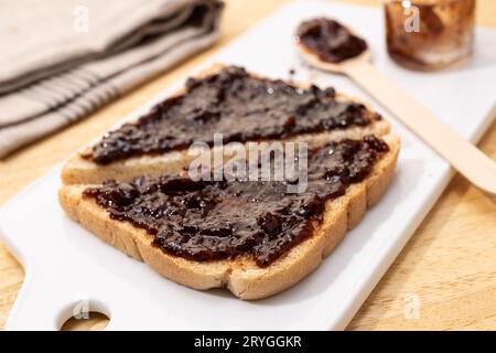 White bread Toast sandwich and raspberry organic jam on wooden table Stock Photo