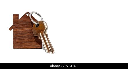 Home keys in a house-shaped keyring isolated on a white background. Stock Photo