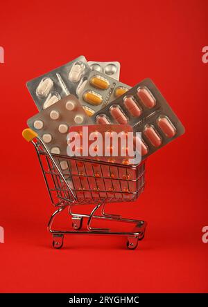 Several blister packs of pills in shopping cart Stock Photo