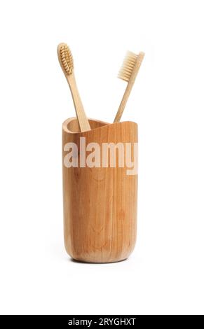 Two toothbrushes in wooden holder on white Stock Photo