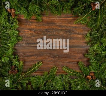 Close up fresh Christmas tree frame over wood Stock Photo