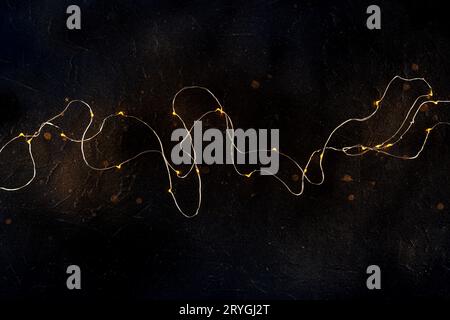 Fairy lights on black. String led garland, shot from the top Stock Photo