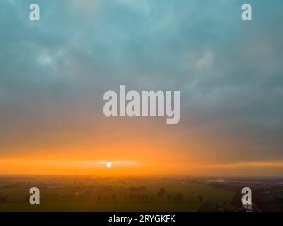 Aerial view of endless lush pastures and farmlands of Belgium under a dramatic colorful sunset sky. Beautiful antwerp countrysid Stock Photo