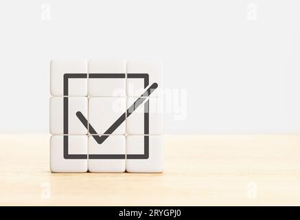 Group of Cube blocks forming a check mark icon. Goals achievement and business success. Copy space Stock Photo