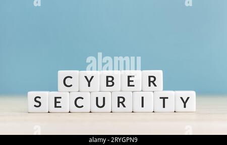 Cyber security concept. Text on cube blocks on blue background. Copy space Stock Photo
