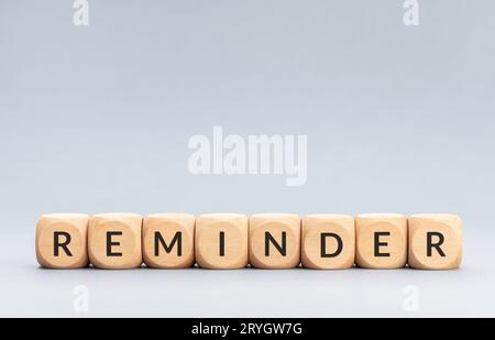 Reminder word on wooden blocks on gray background. Copy space Stock Photo