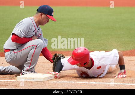 Shaoxing, China's Zhejiang Province. 1st Oct, 2023. Liang Pei (R) of China competes during the Men's Second Group Round A of Baseball at the 19th Asian Games in Shaoxing, east China's Zhejiang Province, Oct. 1, 2023. Credit: Weng Xinyang/Xinhua/Alamy Live News Stock Photo