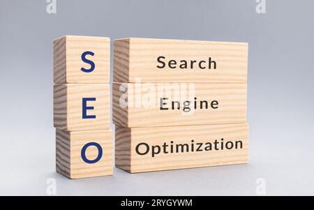 SEO Search Engine Optimization text on wooden blocks on gray background Stock Photo