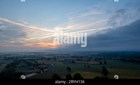 Aerial view of an evening sky over the fields overcast with thunder storm clouds coming in on the sunrise or sunset, taken with Stock Photo