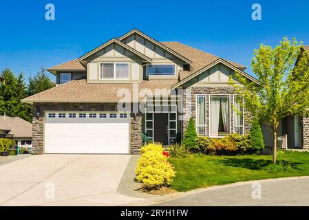 Big family house with concrete driveway to double size garage Stock Photo