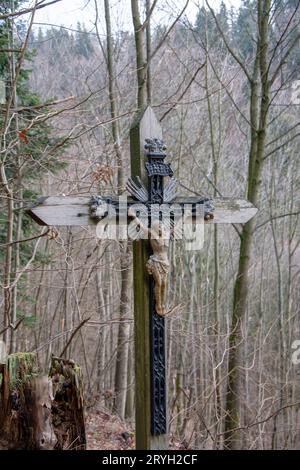 Crucified Jesus Christ on the wooden cross in the forest. Close up. Detail. Stock Photo