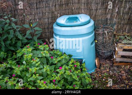 Plastic compost bin in the garden, eco friendly recycling of organic waste Stock Photo