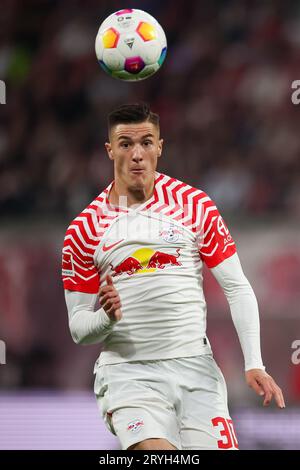 Leipzig's Benjamin Sesko, top, heads the ball during the German