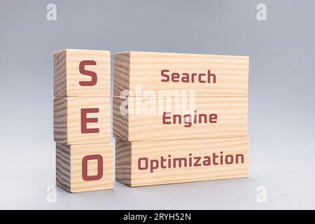 SEO Search Engine Optimization text on wooden blocks on gray background Stock Photo