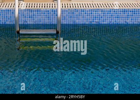 Swimming pool and ladder on a hotel appartment. Luxury vacations. Relaxing holidays Stock Photo
